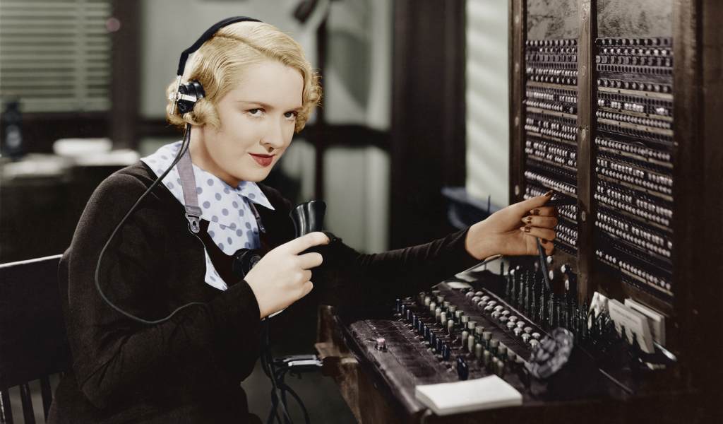 Lady at old fashioned phone switchboard